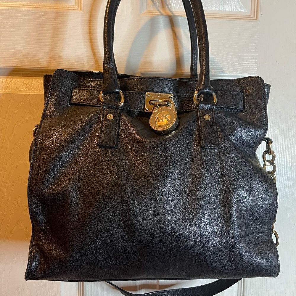 Michael Kors black leather large shoulder bag with gold tone accents.